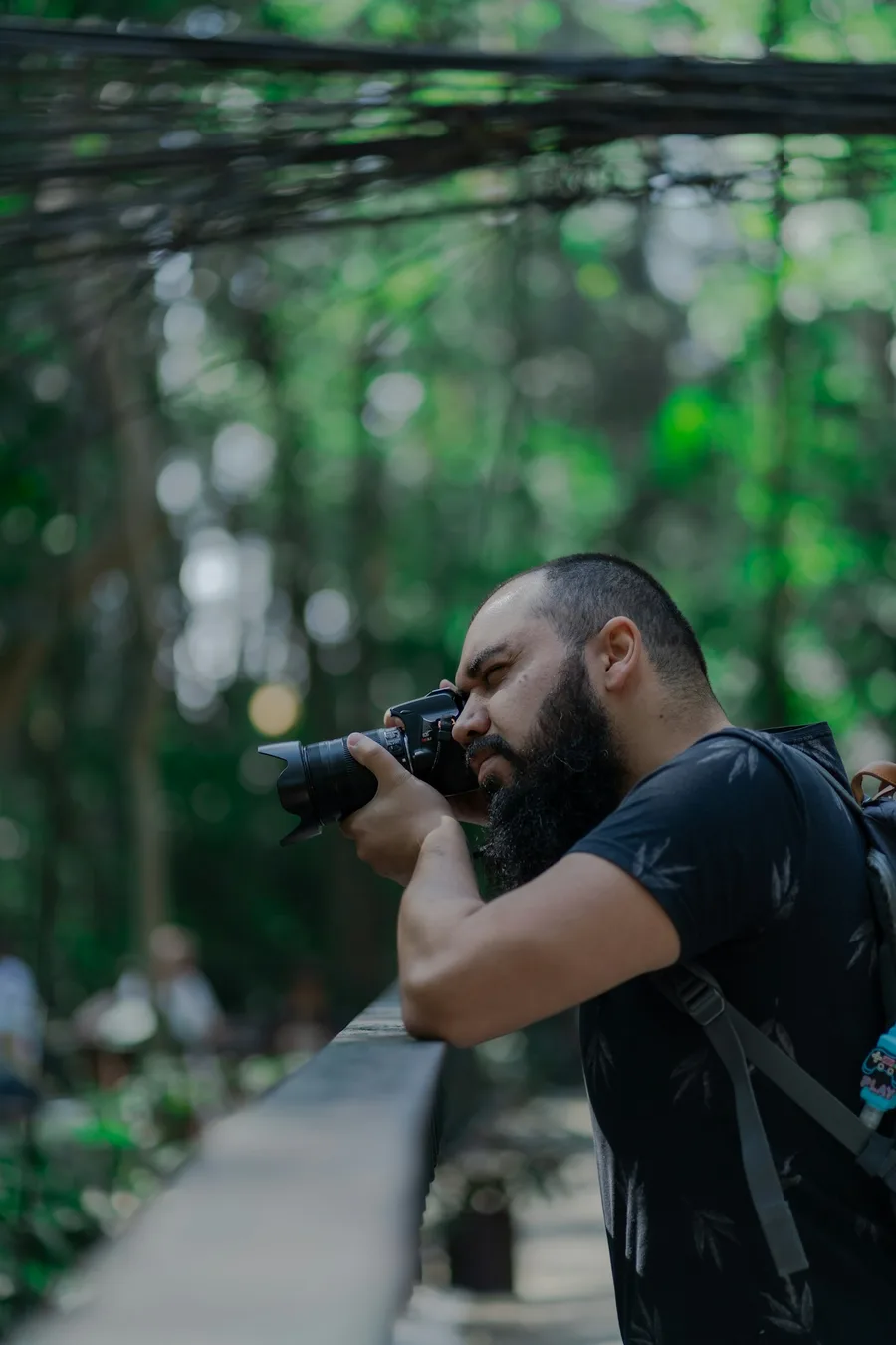 Man taking a candid photo outdoors, illustrating how to choose photos for a genuine dating profile