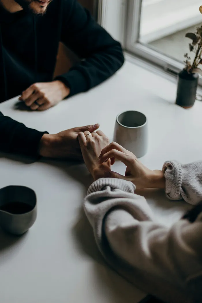 Two people having an honest conversation over coffee