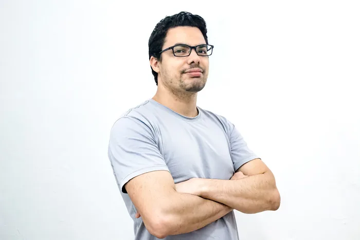 Confident successful man with a quiet, genuine smile, representing the mindset shift from decisiveness to openness
